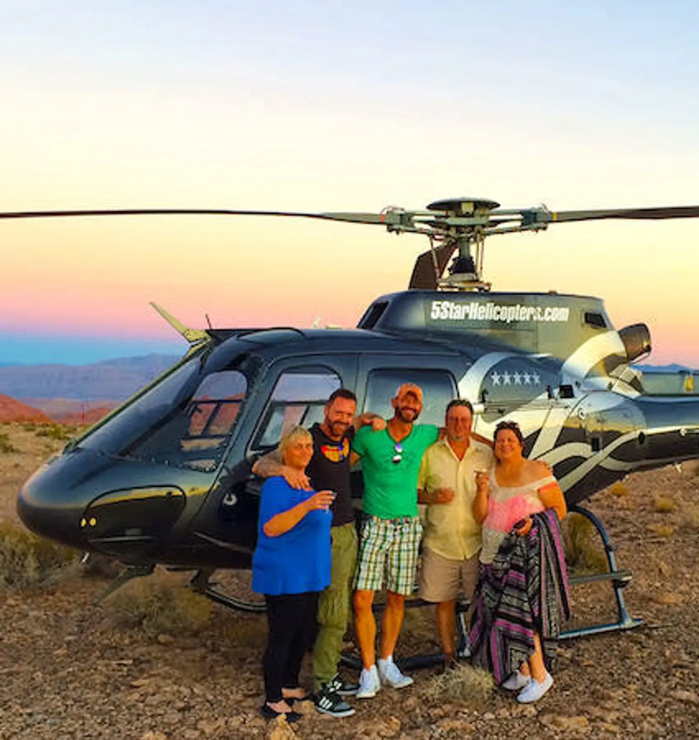 Guests standing beside the helicopter at the landing site